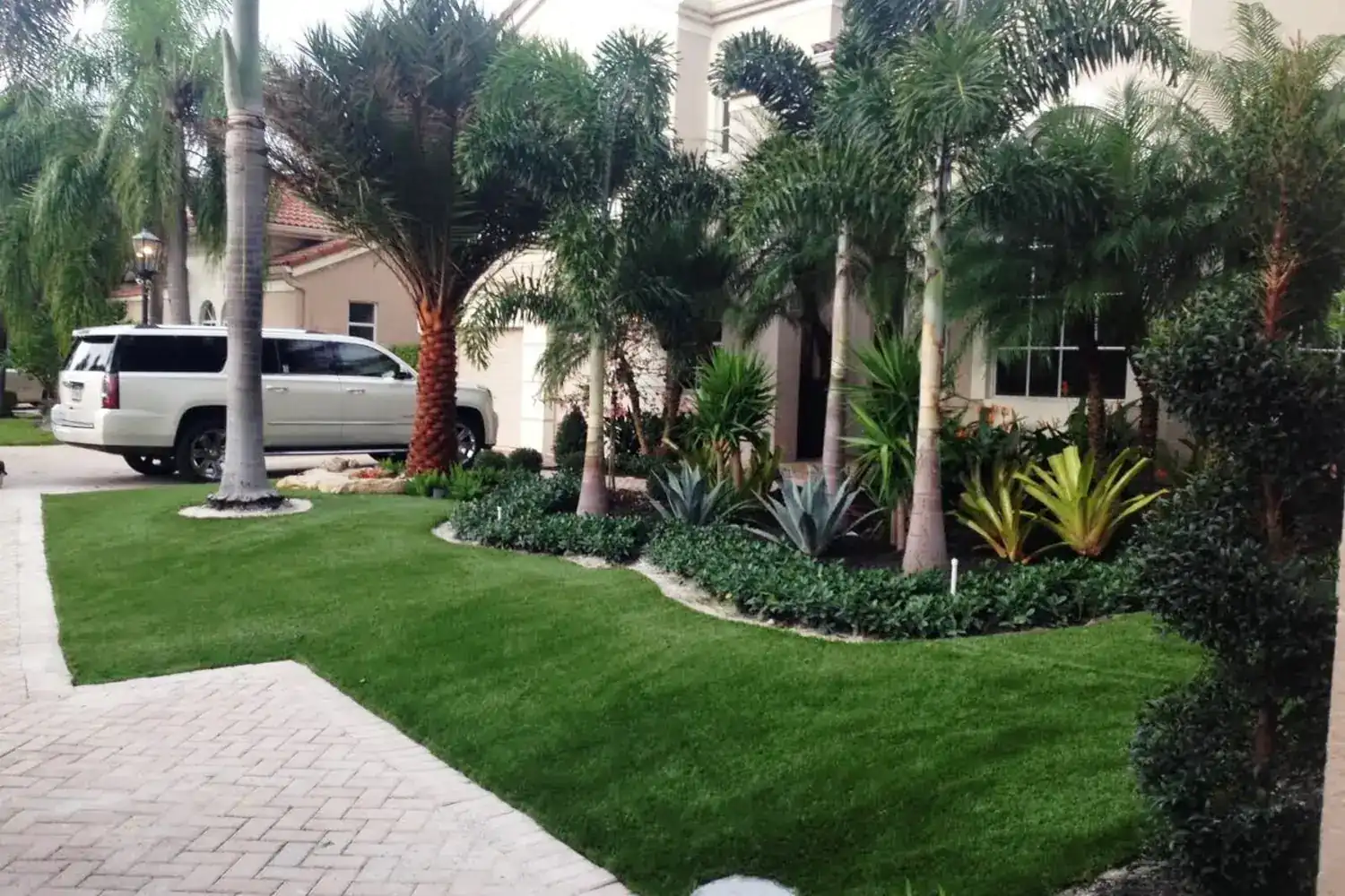 Modern Arizona backyard with a clean artificial turf lawn at sunset
